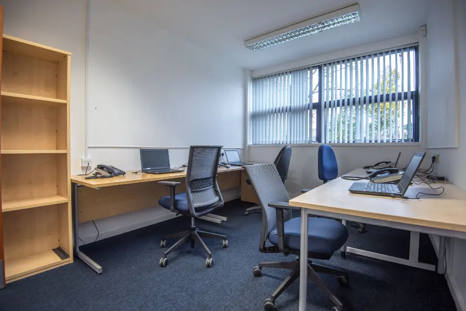 Office 1/7 with windows and bright work area with tables and chairs
