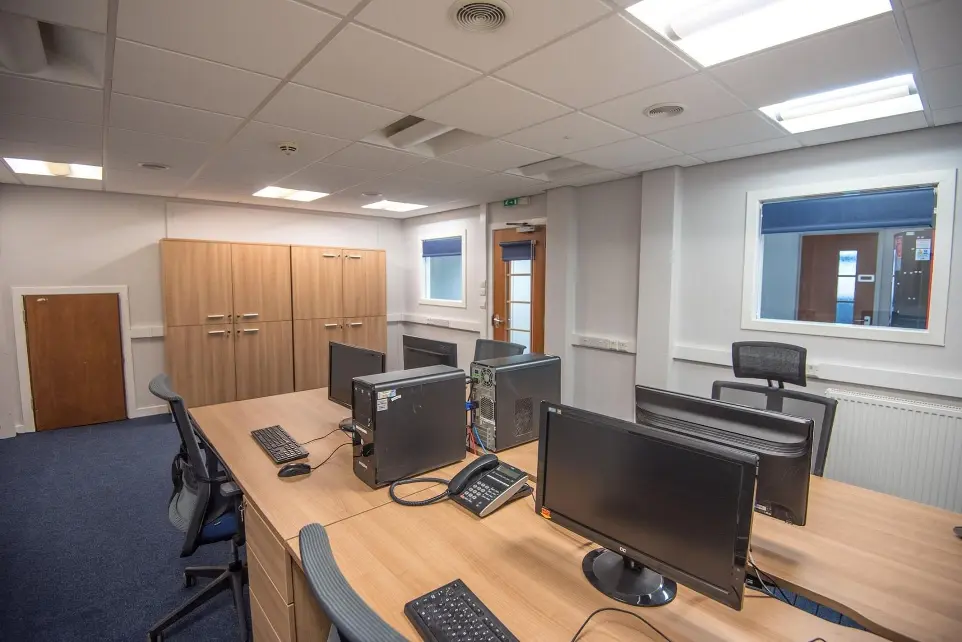 Office 1/10 with windows looking out into the corridor and work spaces