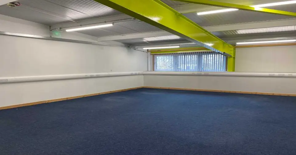 Office Space 2/12 with navy carpet and two large windows